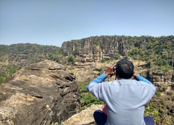 guy watching with binoculars